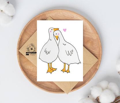 Geese Love greeting card on a wooden plate with kraft envelope