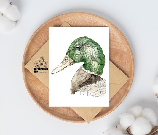 Mallard watercolor greeting card on a wooden plate with kraft envelope