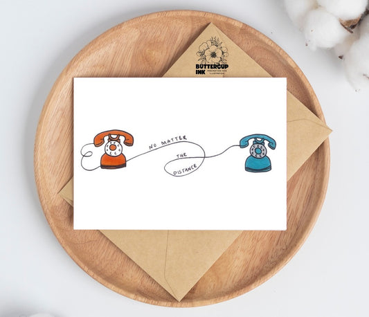 No Matter the Distance greeting card on a wooden plate with kraft envelope