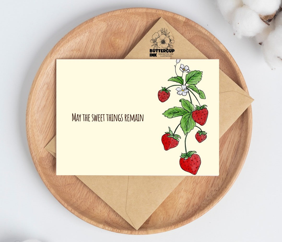 Strawberry loss greeting card on a wooden plate with kraft envelope