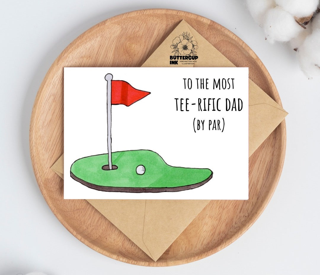 Tee-rific Dad greeting card on a wooden plate with kraft envelope